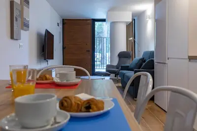 a table with plates of croissants on it in a living room at Travel Habitat Alameda Suites. in Valencia