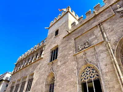 an old building with a clock tower in a city at Apartamento Guimerà in Valencia