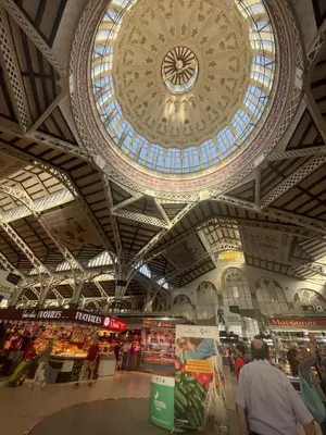 a large building with a large clock on the ceiling at Apartamento Guimerà in Valencia