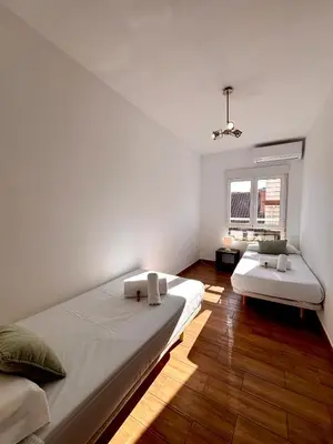 a white bathroom with a tub and a sink at Apartamento Guimerà in Valencia