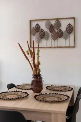 a wooden table with a vase of flowers on it at Nuevo y moderno apartamento con aire acondicionado - El Cid 4 in Burriana