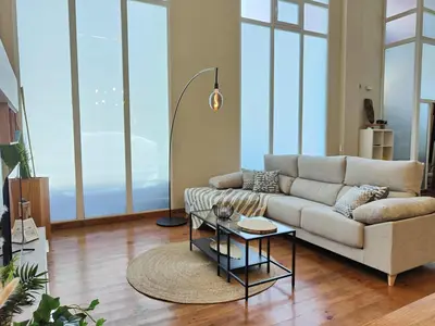 a living room with a couch and a table at The Luxury Apartment in Valencia
