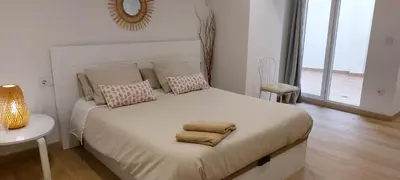 a bedroom with a bed with two towels on it at Holiday Hanna’s House in Valencia
