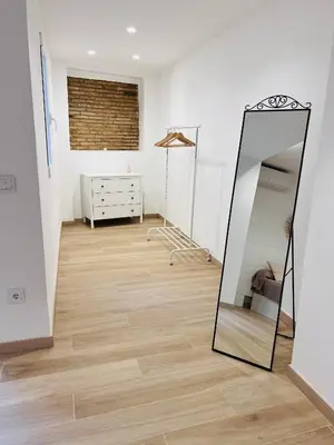 a mirror in a room with a dresser at Holiday Hanna’s House in Valencia