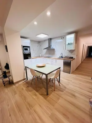 a kitchen and dining room with a table and chairs at Holiday Hanna’s House in Valencia