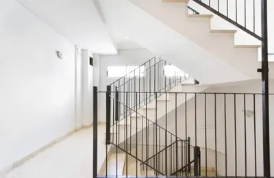 a staircase with black railings in a white house at Apartamento Centro Histórico Valencia de 2 habitaciones in Valencia