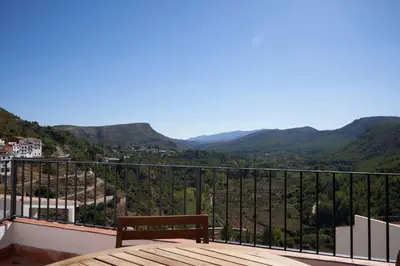 a bench sitting on a balcony overlooking a valley at Ático El Más allá in Chulilla