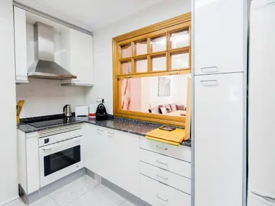 a kitchen with white cabinets and a window at Total Valencia Xàtiva (Leisure & Culture) in Valencia