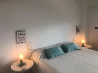 a bedroom with a bed and two tables with candles at Cullera - Florazar II con piscina, tenis y club social in Cullera