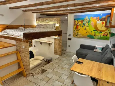 a room with a loft bed and a living room at Dulces Sueños Pilar in Valencia