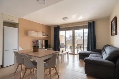 a kitchen and living room with a table and a couch at Nuevo apartamento en playa con aire acondicionado MASBO 3 in Moncófar