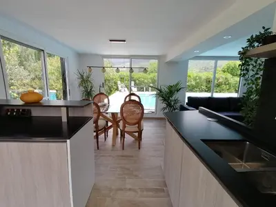 a kitchen and living room with a table and chairs at Villa Isabelle in Barraca de Aguas Vivas