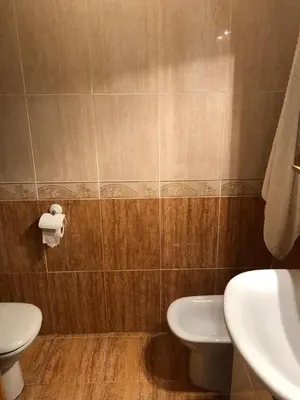 a bathroom with a white toilet and a sink at Acogedor apartamento en el grau de Moncofa con wifi in Moncófar