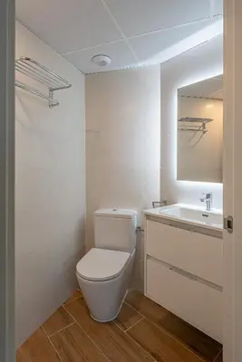 a bathroom with a white toilet and a sink at TOP DUPLEX NUEVO A ESTRENAR ,CIUDAD DE LAS CIENCIAS in Valencia