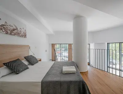 a bedroom with a large bed with two pillows at TOP DUPLEX NUEVO A ESTRENAR ,CIUDAD DE LAS CIENCIAS in Valencia
