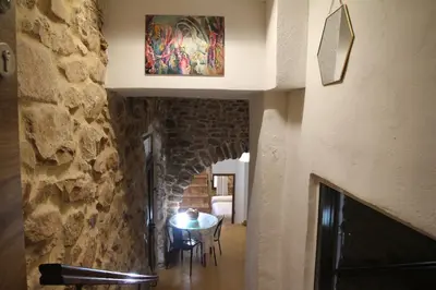 a hallway with a table and a stone wall at Casa rural rústica 