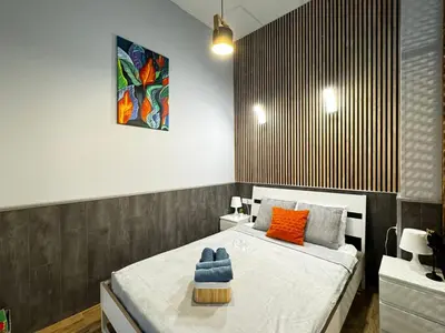 a bedroom with a bed with orange and blue pillows at Lliri 32 in Valencia