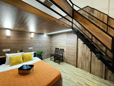 a bedroom with a large bed and a staircase at Lliri 32 in Valencia