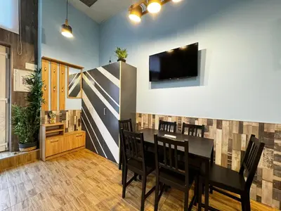 a dining room with a table and a tv on a wall at Lliri 32 in Valencia