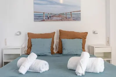 a bedroom with a bed with towels on it at Patacona Breeze in Valencia