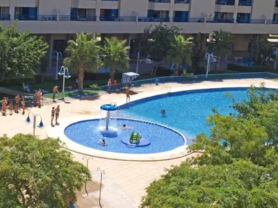 a large swimming pool with people playing in it at Patacona Breeze in Valencia