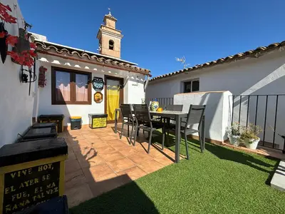 a patio with a table and chairs in a house at ÁTICO RURAL 