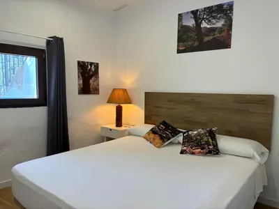 a bedroom with a large white bed and a lamp at ÁTICO RURAL 