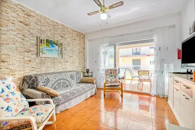 a living room with a couch and a table at Relax Les Palmeres in Sueca