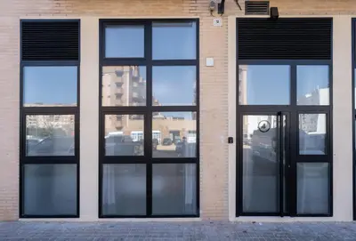 a brick building with black doors and windows at Vip Apartments Valencia in Valencia