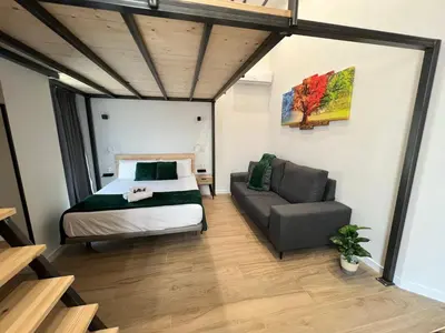 a bedroom with a bed and a couch at Vip Apartments Valencia in Valencia