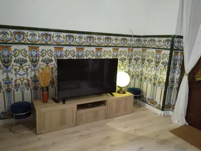 a living room with a flat screen tv on a wall at Casa con encanto y terraza junto a la playa in Valencia