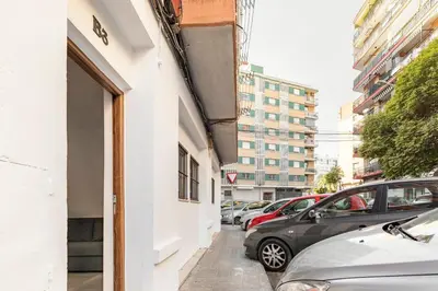 a street with cars parked on the side of a building at Vivienda junto a Ruzafa - 12 PAX y más in Valencia
