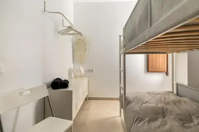 a bedroom with a bunk bed and a desk at Vivienda junto a Ruzafa - 12 PAX y más in Valencia