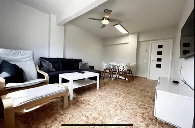 a living room with a couch and a table at Beach Retreat in Valencia