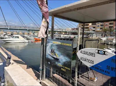 a sign on a marina with boats in the water at Beach Retreat in Valencia