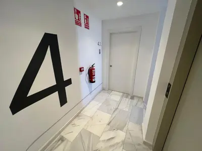 a hallway with a fire hydrant on a wall at Old Town Flats Casa del Bisbe in Valencia