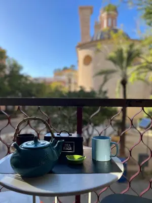 a table with a tea pot and a cup on a balcony at Plaza del Carmen Boutique in Valencia