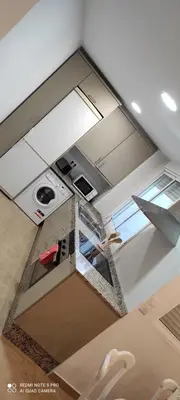 an overhead view of a kitchen with white cabinets at TU CASA en Benetússer , VALENCIA in Benetúser