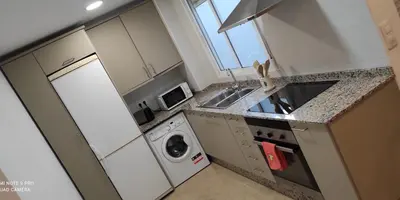 a kitchen with a sink and a washing machine at TU CASA en Benetússer , VALENCIA in Benetúser