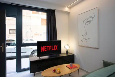 a living room with a tv and a coffee table at Neobeds - Stylish modern 1BR Apt Near Old Town & Steps from Turia Park in Valencia