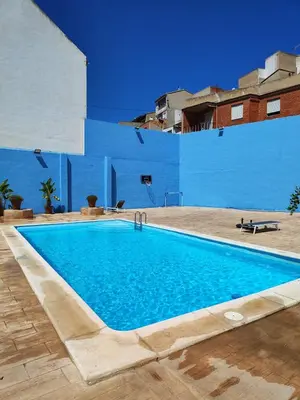 a swimming pool in the middle of a building at El Recreo, private Pool & Bbq in Godelleta