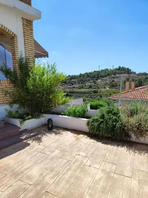 a patio with a bunch of plants on a house at El Recreo, private Pool & Bbq in Godelleta