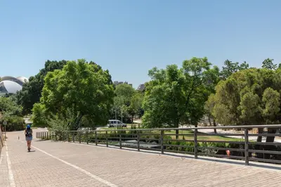 a woman walking on a bridge in a park at ApartUP Opera Loft Love in Valencia