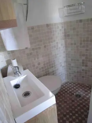 a bathroom with a white toilet and a sink at Young Penthouse in Valencia