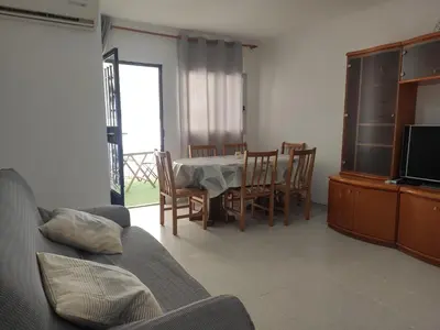 a living room with a table and chairs and a television at Apartamento rural Casa Calo in Losa del Obispo