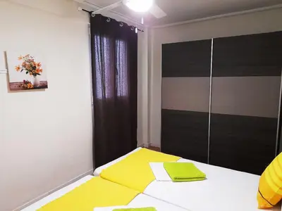 a bedroom with a yellow and white bed with a window at Double cozy room. Ruzafa - perfect place to stay in Valencia