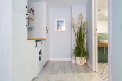a white laundry room with a washer and dryer at Le Méditarranéen de COUP DE COEUR APPARTEMENTS in Valencia