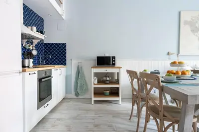 a kitchen with a table and chairs in a room at Le Méditarranéen de COUP DE COEUR APPARTEMENTS in Valencia