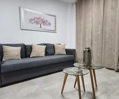 a living room with a couch and a table at Magnifico apartamento cerca del centro con A.A. - CID 2 in Burriana