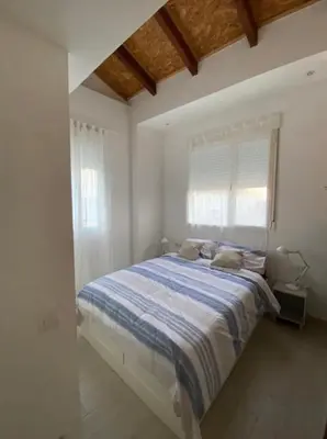 a kitchen with white cabinets and a black counter top at VALENCIA RENT APARTS MILAGROSA 1 in Valencia